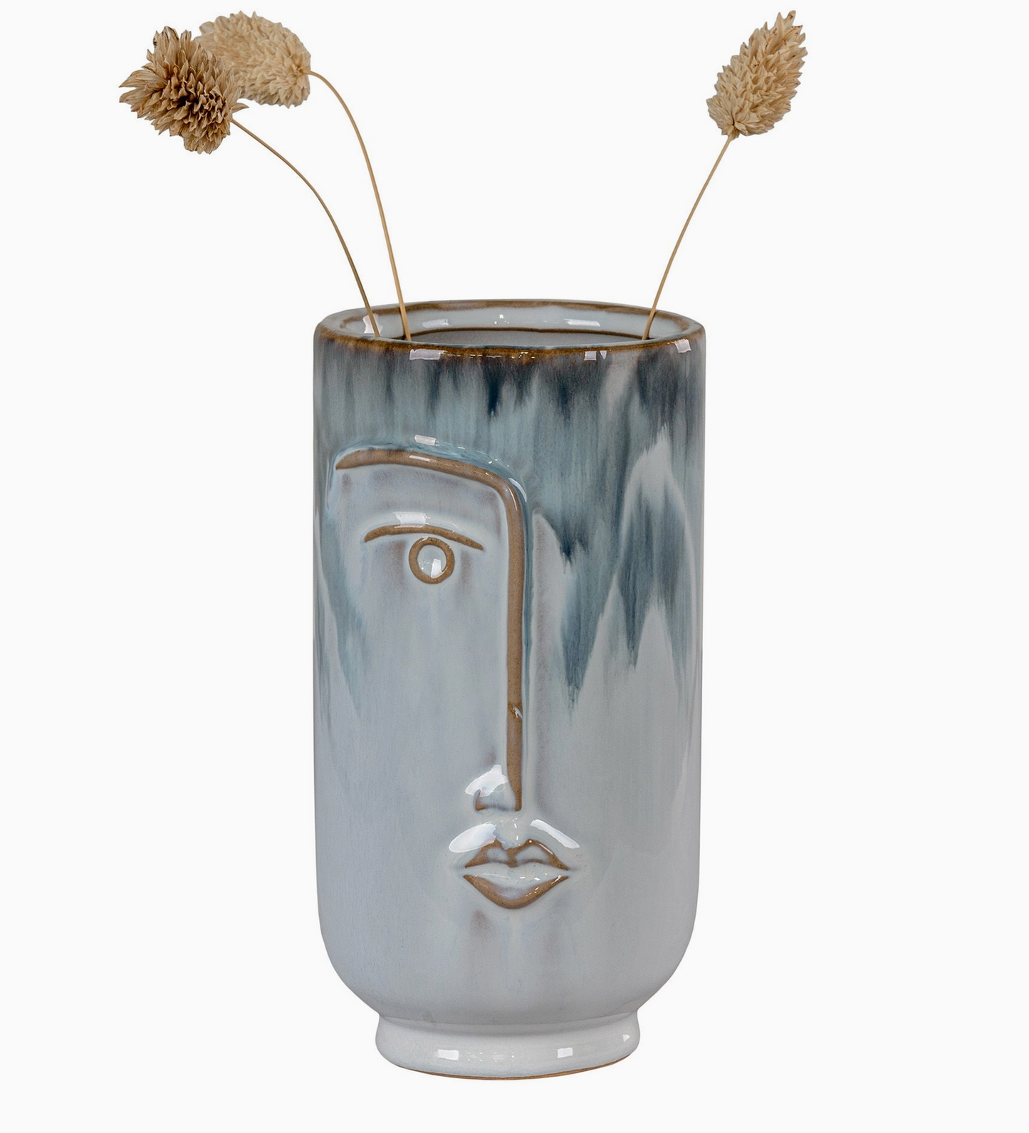 Vase visage avec fleurs séchées sur une console